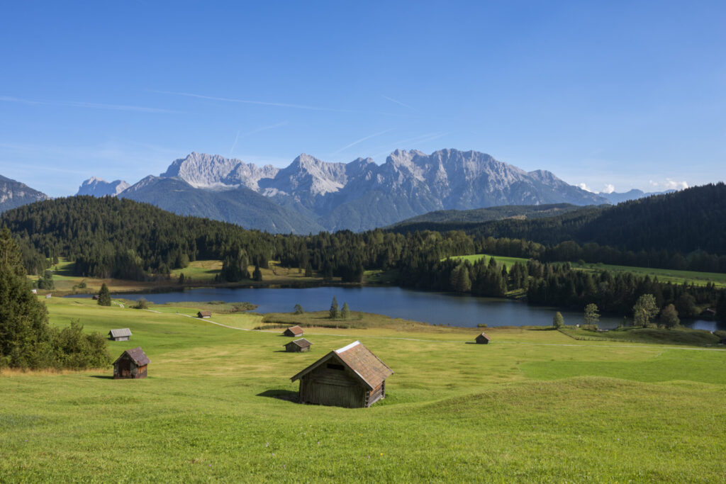 Germany Bavaria Geroldsee Lake with huts in foreground and Karwendel mountains in background › 스타일리쉬 플레이스 자연 속에서 명상과 요가를 즐길 수 있는 평화로운 여행지